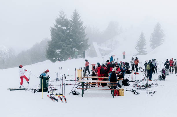 Lurisia, Piedmont, Italy Lurisia, Piedmont, Italy, January 2014. Lurisia is a ski resort located in southwestern Piedmont. Frequented by a certain number of tourists, it is a few kilometers from large cities such as Turin or Genoa. In this image you can see some skiers who are preparing to use the ski lifts. snowboarding snowboard women snow stock pictures, royalty-free photos & images