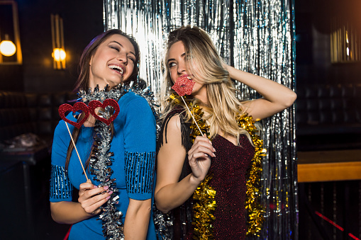 Portrait of happy young female friends together at nightclub