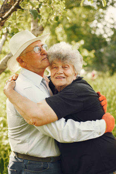 istock Beautiful old couple spend time in a summer garden 1286354513
