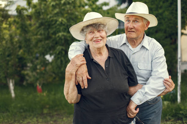 istock Beautiful old couple spend time in a summer garden 1286354586