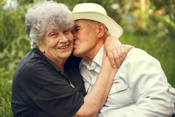 istock Beautiful old couple spend time in a summer garden 1286354655