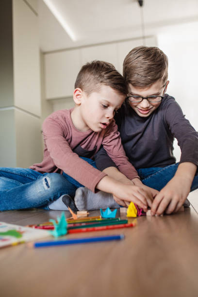 istock Brothers are playing at home 1286354833