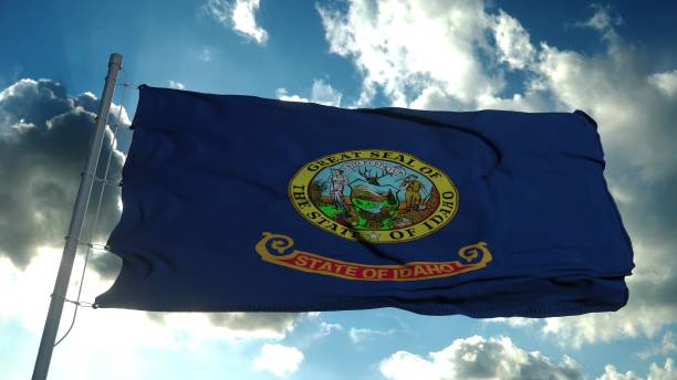 istock Idaho flag on a flagpole waving in the wind in the sky. 3d rendering 1286355157