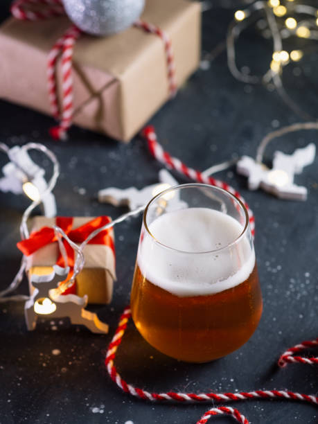 istock Christmas table with a glass of beer, gift boxes, garlands 1286357351