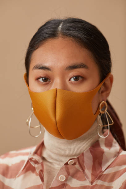 istock Asian woman in mask 1286357501