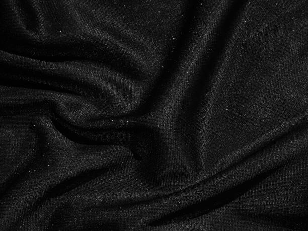 istock Shiny black crumpled fabric texture. Elegant cloth background 1286358138