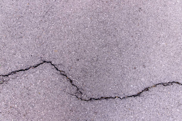 istock Close-up concrete asphalt exterior cracked seamless patterned texture 1286358961