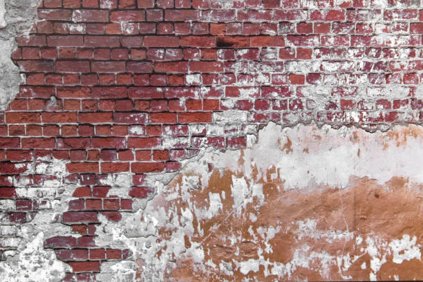 istock Close-up concrete exterior cracked seamless pattern dirty plaster brick texture. 1286359129