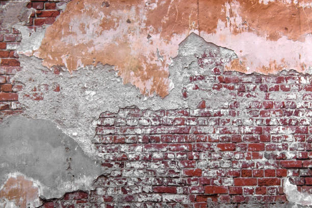 istock Close-up concrete exterior cracked seamless pattern dirty plaster brick texture. 1286359227