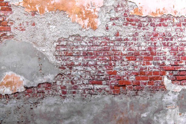 istock Close-up concrete exterior cracked seamless pattern dirty plaster brick texture. 1286359285