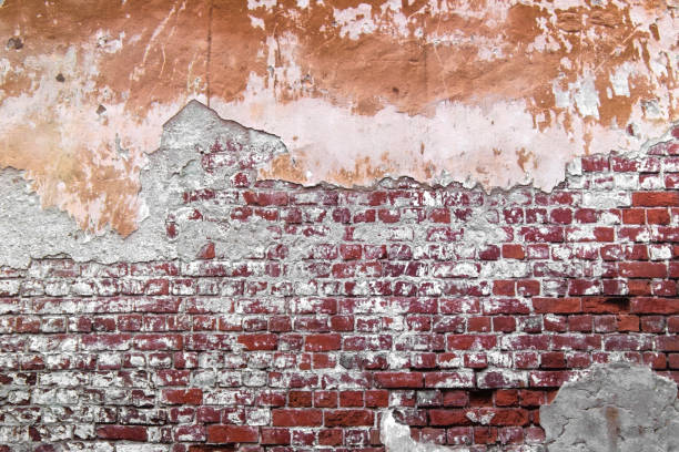 istock Close-up concrete exterior cracked seamless pattern dirty plaster brick texture. 1286359466