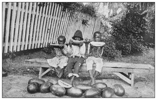 Antique black and white photo of the United States: Children eating watermelons