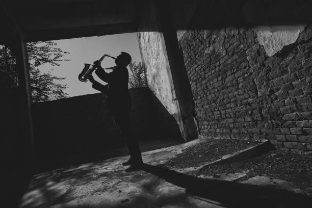 istock Man playing saxophone in an abandoned building 1286361174
