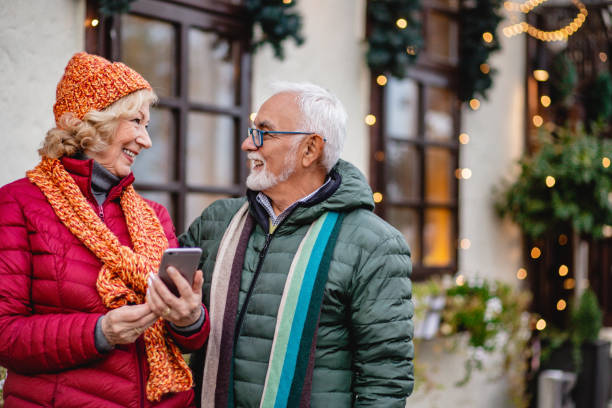 istock Senior couple is using mobile phone outdorrs 1286361488