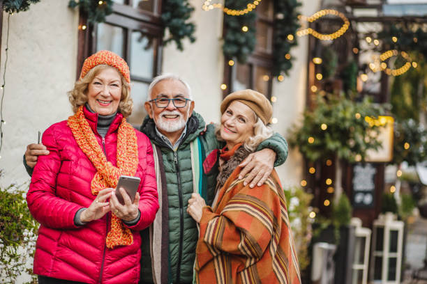 istock Group of seniors outdoors using mobile phone 1286361653