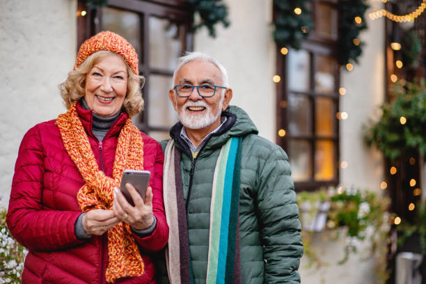 istock Senior couple is using mobile phone outdorrs 1286362306