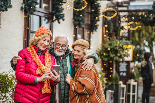 istock Group of seniors outdoors using mobile phone 1286362329