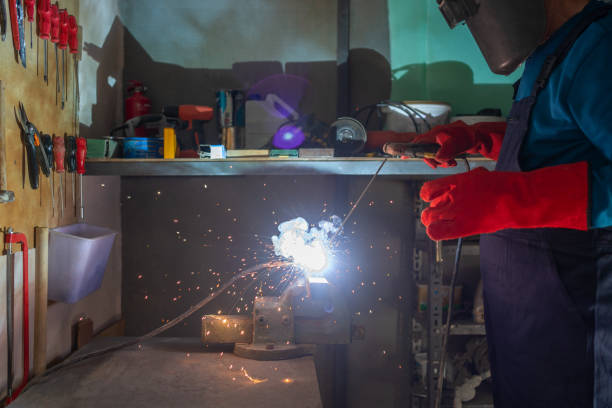 istock A senior man is working in home workshop garage with manual arc welding machine on steel structure and wearing safety welding mask and construction gloves while blue sparks fly to the sides 1286364372