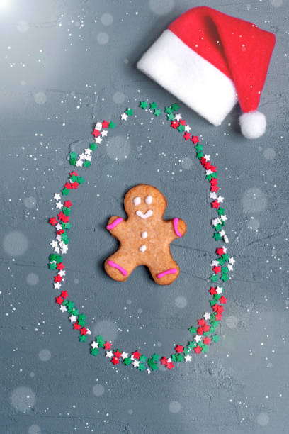 istock Gingerbread man surrounded by star sugar sprinkle and santa hat 1286364428