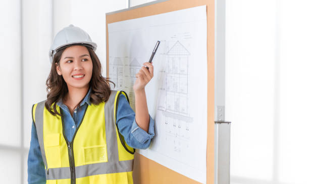 istock Female Architect engineer is presenting her construction plan on blackboard in a business meeting. 1286365655