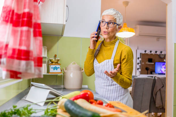 istock Senior woman cooking. 1286368244