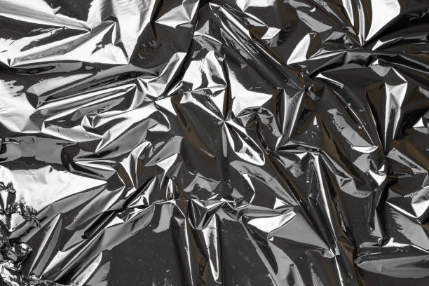 istock Black background. Black shiny film bag pattern. Wrap transparent dark cellophane texture. Creative crumpled background. 1286368551
