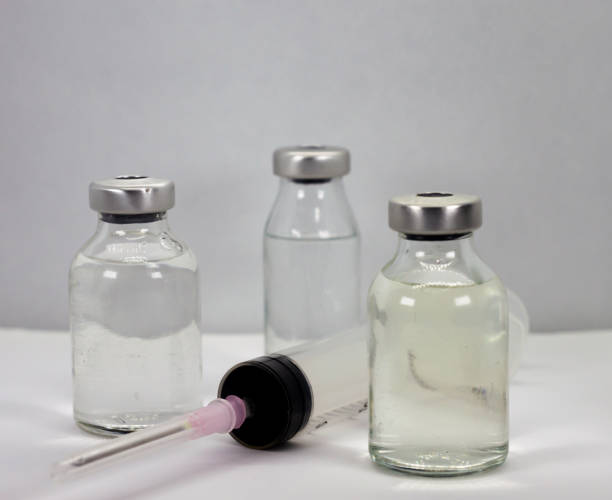 istock Vaccine vials and syringe on white background 1286369088
