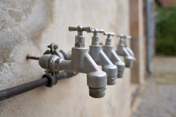Taps for water supply in the garden on the facade of a house