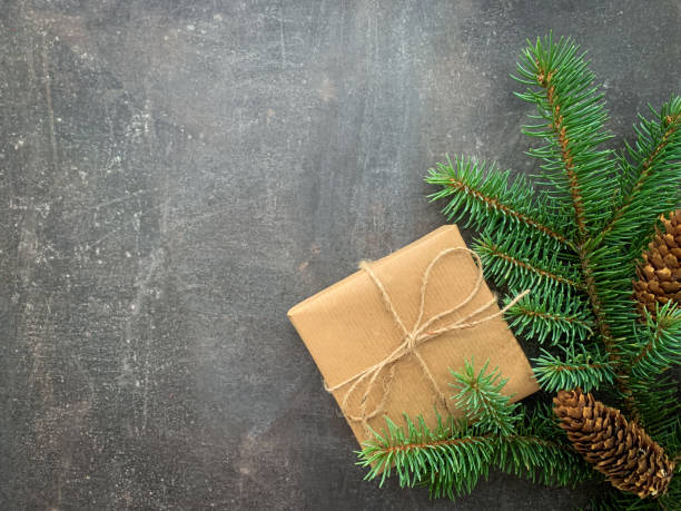 istock Christmas background with fir tree, pine cones and handmade gift box. 1286371816