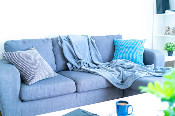 istock Living room interior: gray couch with blanket and pillows 1286371928