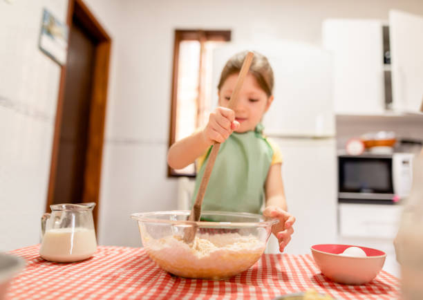 istock Little girl preparing a cake recipe 1286371981