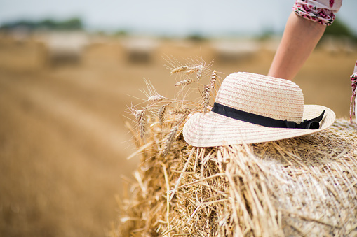 straw hat on the grass with wheat spikelets