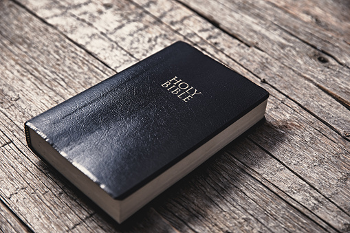 Holy Bible on the grey wooden table background