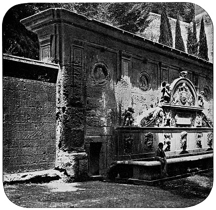 Pilar de Carlos V (Fountain of Charles V) at Alhambra in Granada, Spain. Vintage halftone photo etching circa 19th century. Extensive restorations were done in early 20th century, radically changing the location.