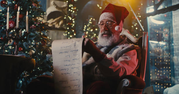 istock Happy Santa Claus checking messages from good children 1286378433