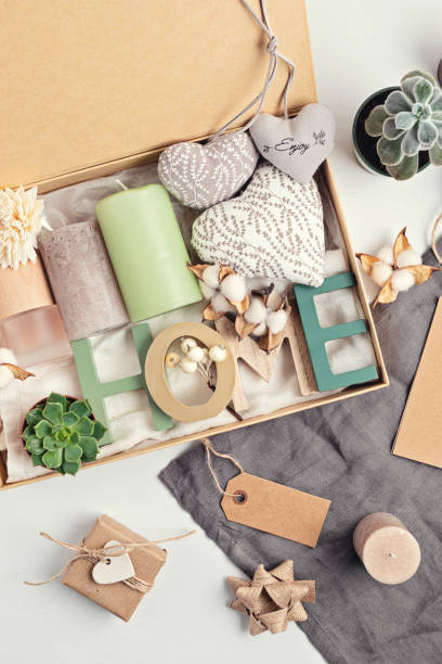 istock Preparing care package, seasonal gift box with candles, succulent, interior scent. Personalized eco friendly basket 1286378573