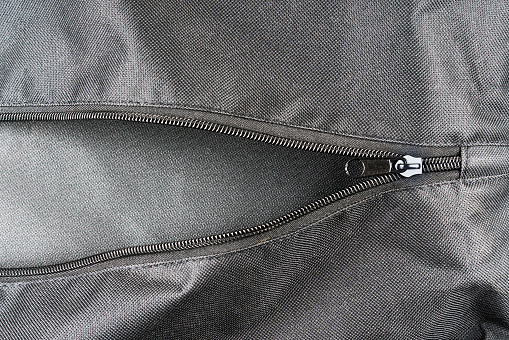 closeup shot of a black zipper  on a black leather jacket.