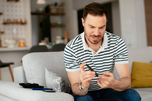 istock Young man checking blood sugar stock photo. 1286383516