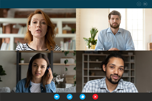 Screen application view of diverse multiracial businesspeople talk speak on video call, engaged in team online meeting. Multiethnic colleagues have webcam group virtual conference or web briefing.