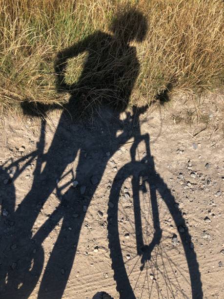 istock Shadow of a woman with a bicycle 1286384785
