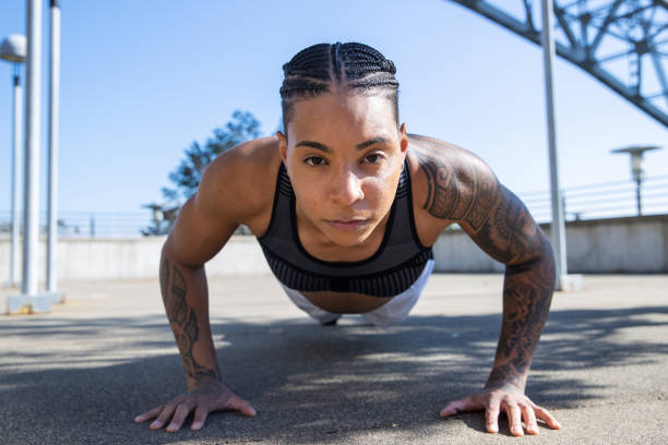 istock Strong African American woman doing push ups outside 1286384898