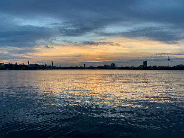 istock Stunning sunset over Alster river and dark Hamburg skyline 1286385409