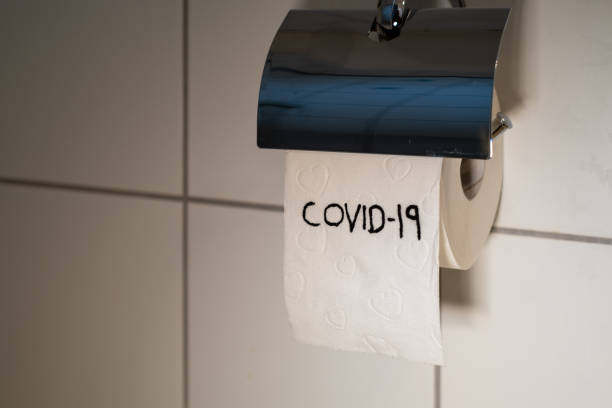istock on a toilet paper roll stands Covid-19 1286385968