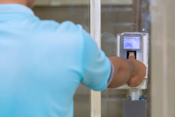 istock The hand are scanning on fingerprint machine for enter digital security door system in the office building at Bangkok ,Thailand.  Fingerscan with access control on the glass door. 1286386272