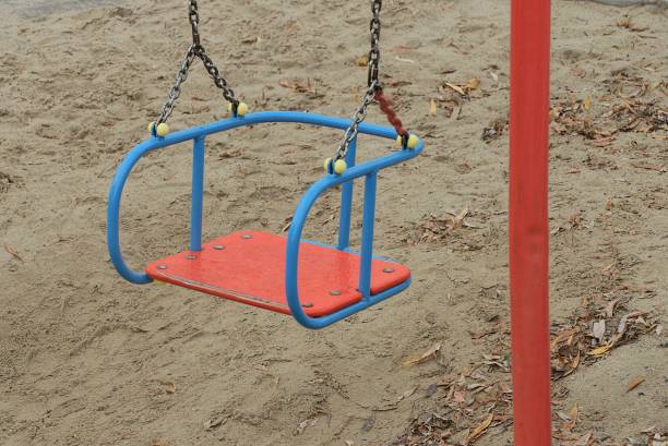 istock one empty color swing seat hanging on gray iron chains outdoors 1286388557