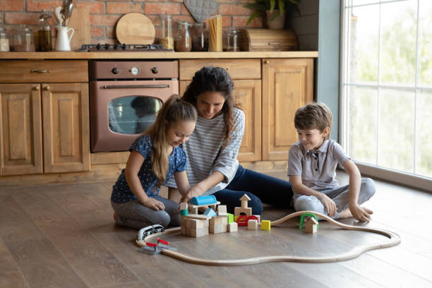 istock Loving mom play at home with two small kids 1286390224
