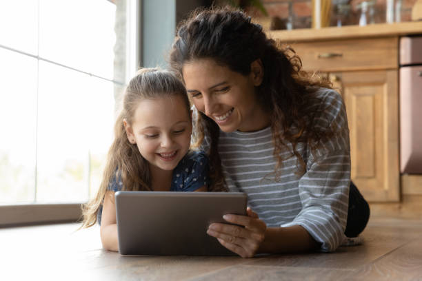 istock Happy mom and small daughter using tablet together 1286390234