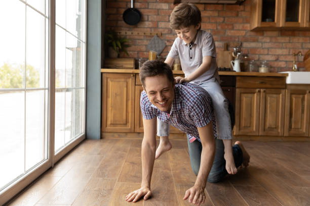 istock Happy small boy ride loving young dad playing 1286390238