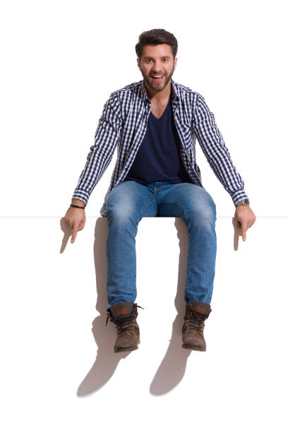 istock Young Man Is Sitting On A Top, Pointing Down And Talking 1286390438