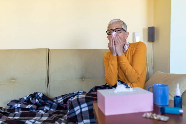 istock Sick Senior Woman is Lying in the Bed Due to High Temperature and Respiratory System Problems. 1286391345